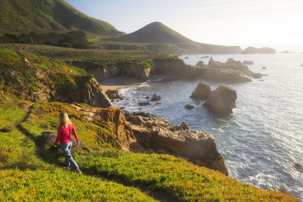 Woman Walk along the Rocky Beachside