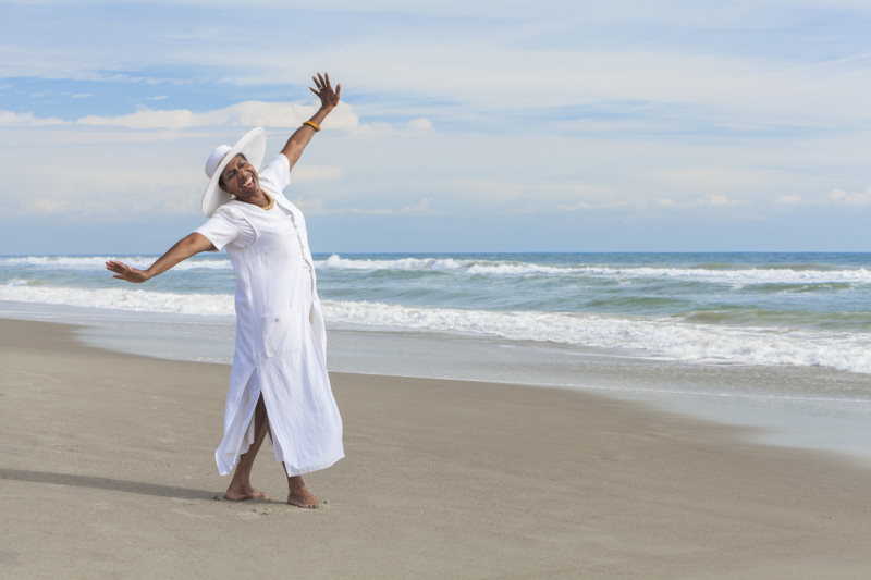 Senior Woman Dancing on Beach